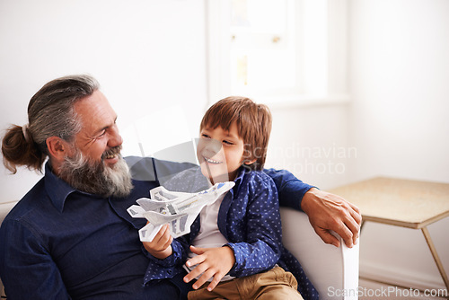 Image of Dad, son and play with toy, airplane and fun in home or house with joy. Father, child and happiness with smile, youth and childhood development for future growth and bonding or single parent care