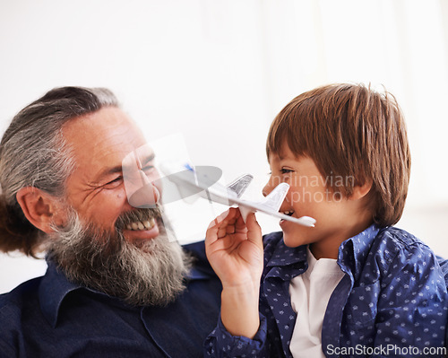 Image of Grandfather, kid and play with toy, plane and fun in home or house with joy. Mature man, child and happiness with smile, youth and childhood development for future growth and bonding or care together