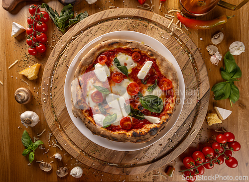 Image of Delicious Italian pizza on rustic wooden table