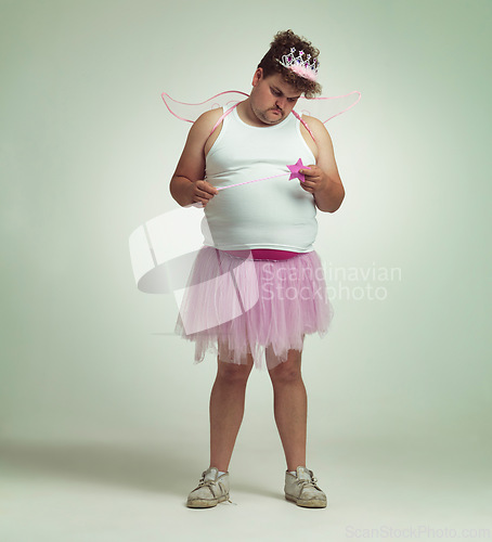 Image of Fairy, man and studio portrait for magic and isolated, sad male person with wings and pretend costume. Pink Cosplay, depressed and mature plus size model, dress up or role play on white background