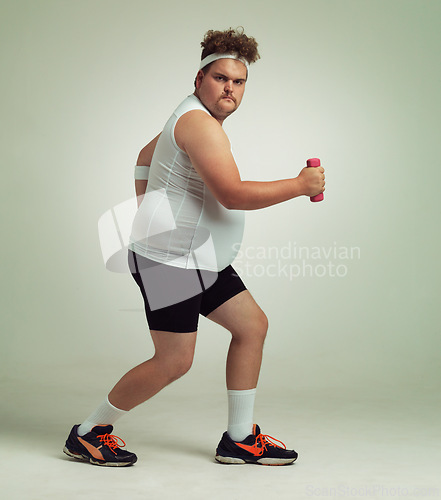Image of Man, lunge and dumbbell in studio for portrait, plus size and exercise for weight loss on background. Male person, training and gym equipment for strength, challenge and body development in workout