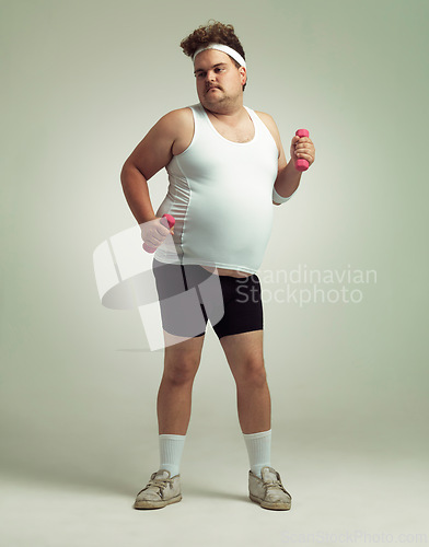 Image of Man, plus size and dumbbells for exercise in studio on white background for health, weight loss and fitness. Workout, diet and committed for wellbeing with weights for training, care and confidence