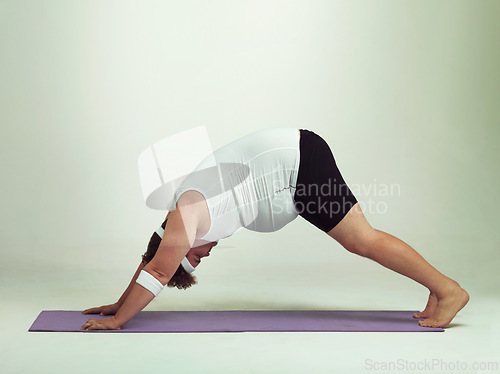 Image of Man, plus size and exercise with mat in studio on white background with stretching or workout and fitness. Healthy, confident and progress with body positivity for self care, wellness and wellbeing