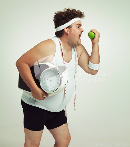 Image of Scale, man and apple for health, fitness or nutrition isolated on a gray studio background mockup. Plus size, eating fruit and healthy diet for weight loss of body of funny person with tape measure