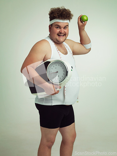 Image of Scale, happy man and portrait with apple for fitness, health or nutrition isolated on gray studio background mockup. Plus size, fruit or diet for weight loss of body of male person with tape measure