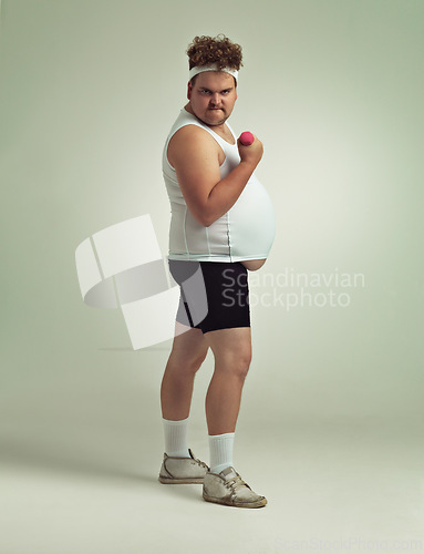 Image of Man, portrait and dumbbell in studio for power, plus size and exercise for weight loss on background. Male person, training and gym equipment for strength, challenge and body development for fitness