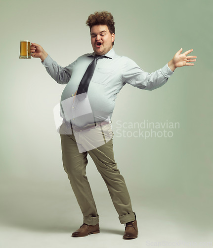 Image of Man, beer and proud with belly for celebration, drink or party on a studio background. Male person or plus size model with glass or mug in satisfaction for beverage, wine or drinking on mockup space