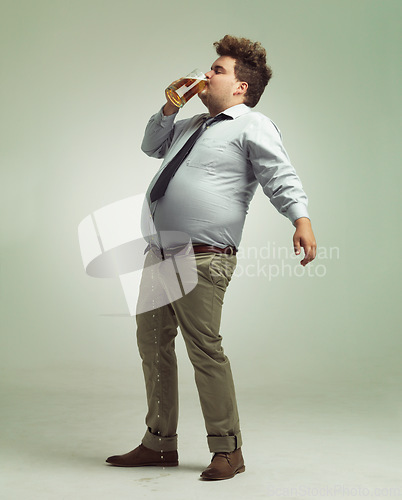 Image of Studio, drunk and man with beer or alcohol with pint glass to drink, professional and profile. Adult, male person and guy with beverage for break, fun and crazy in party with liquid from mug