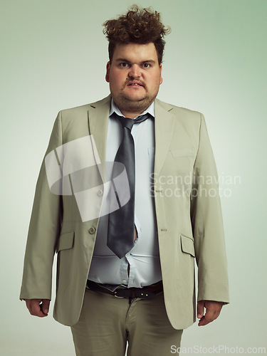 Image of Plus size, portrait and man with stomach, shirt and professional annoyed with clothes for work. Adult, male person and guy with moody, unhappy and upset with fitting of belly in suit in studio job