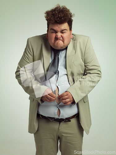 Image of Plus size, man and fitting in shirt for abdomen, professional and annoyed with clothes for work. Adult, male person and guy with stomach, unhappy and upset with of belly in suit for job in studio