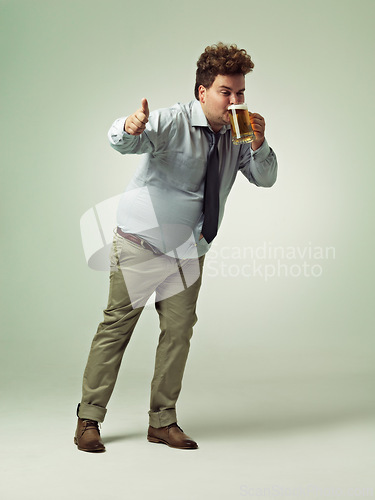 Image of Man, portrait and thumbs up with beer for celebration, drink or party on a studio background. Male person or plus size model with like emoji, yes sign or OK for alcohol satisfaction on mockup space