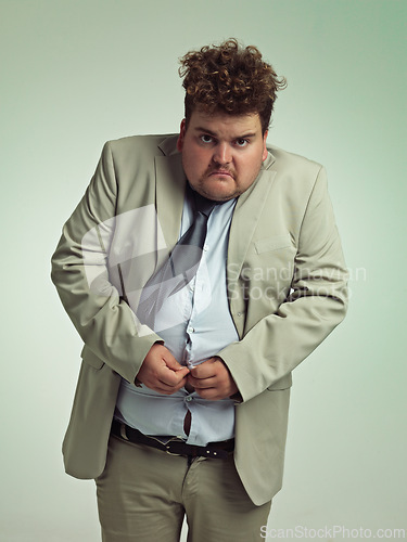 Image of Portrait, plus size and man with stomach in shirt for suit, professional and annoyed with clothes for work. Employee, male person and guy with unhappy with fail of belly in attire for job in studio