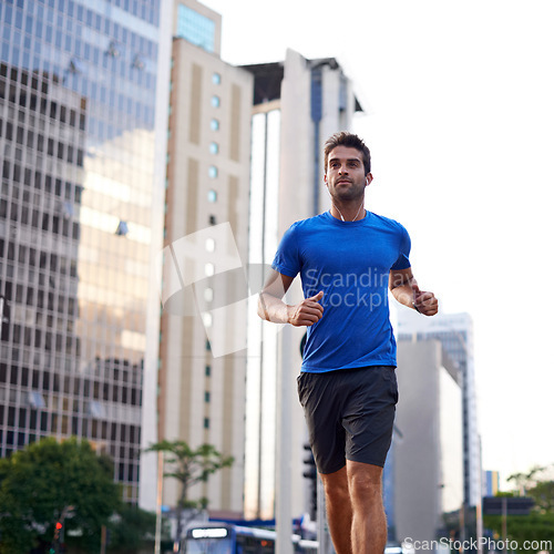 Image of Fitness, health and man running in city training for marathon, competition or race. Exercise, wellness and male athlete with outdoor cardio workout for endurance, energy or speed in urban town