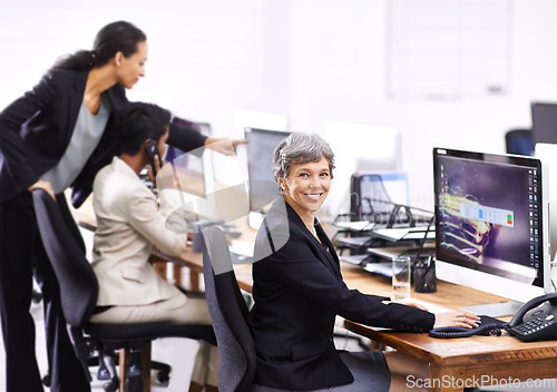 Image of Business woman, portrait and coworking in an office with computer, employees and internet at company. Desktop, professional and female person with technology of website manager at a desk with worker