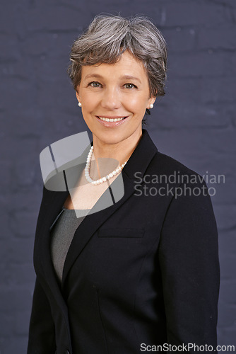 Image of Senior woman, portrait and corporate professional with smile, pride and ambition on wall background. Management, confidence and real estate agent in London with empowerment and happy in career