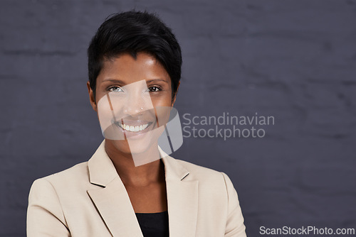 Image of Indian woman, portrait and professional in business with smile, pride and ambition with confidence on wall background. Happy in corporate career, job satisfaction and real estate agent in Mumbai