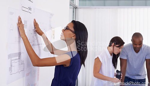 Image of Woman, architect and planning with board of documents or paperwork in meeting for architectural design at office. Female person, contractor or designer with team for floor plan or ideas at workplace