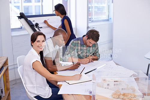 Image of Happy woman, creative and portrait with architect team for meeting, planning or architectural design at office. Designer with smile, documents or paperwork in group project or startup at workplace