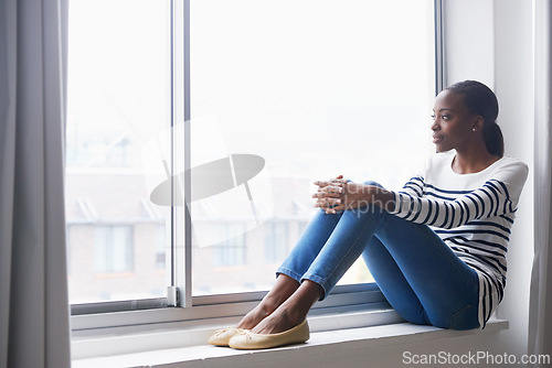 Image of Woman, smile and thinking on window by new house for relax, property investment or homeownership in lounge. African tenant, person or daydreaming of interior ideas for living room or relocation pride