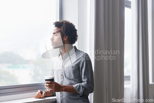 Image of Man, coffee and thinking by window in new home with confidence for real estate investment and mortgage. African homeowner, person and thoughtful with future house ideas and relocation in living room