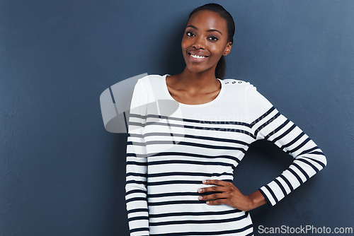 Image of Portrait, smile and black woman with fashion, confidence and stylish clothes on a grey studio background. African person, model and girl with casual outfit and trendy with happiness and cheerful lady