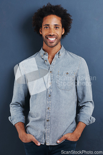 Image of Happy man, portrait and confident in studio as creative professional and casual fashion by blue background. Young person, face or smile for ambition as designer in trendy clothes or pride in mock up