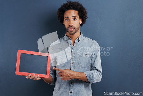 Image of Blackboard, portrait and man with hand pointing to mockup in studio for news announcement on grey background. Frame, presentation or face of male model show space for promotion, info or sign up guide