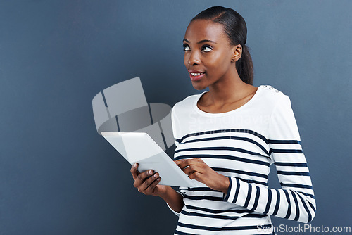 Image of Black woman, tablet and thinking about ideas for research, internet and social media with influencer on blue background. Digital, touchscreen and brainstorming for content creation with inspiration