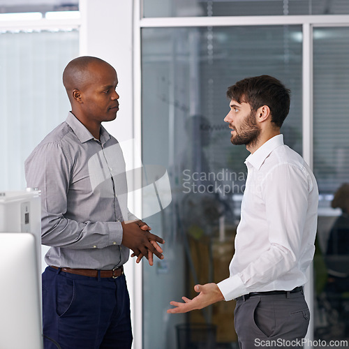 Image of Men, discussion and conversation in hallway at office for ideas, listen or collaboration at company. Business people, teamwork and diversity with advice for questions in workplace at corporate agency