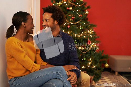 Image of Christmas, love and black couple in home on holiday or holding hands on vacation with happiness. Festive, tree and people embrace with care and support in house or excited to celebrate together