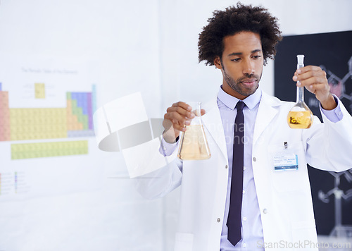 Image of Scientist, man and beaker with chemical for study, medical research and pharmaceutical solution in laboratory. Science, african professional and test sample for expert clinical investigation at work