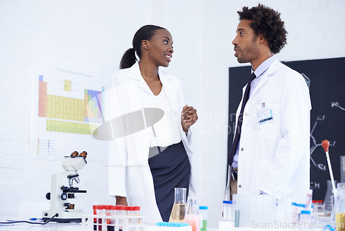 Image of Scientist, man and woman with discussion in laboratory for chemical research, medical review and study feedback. Science, african expert and collaboration with communication and chemistry planning