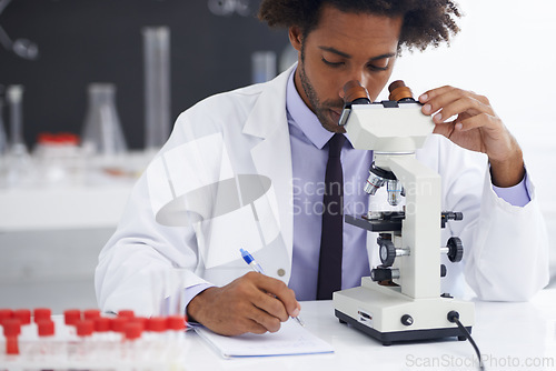 Image of Research, microscope and man scientist writing in notebook in office for medical, experiment or inspection. Science, healthcare and African health expert with virus study, testing or dna analysis