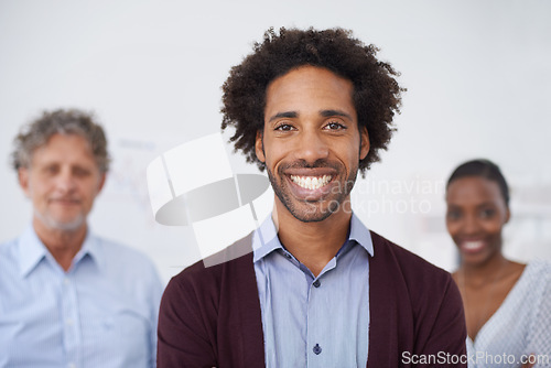 Image of Man, smile and portrait in office with colleagues for collaboration, meeting and career for organisation, agency or company. Diverse, team, coworkers and happy for teamwork and profession for job