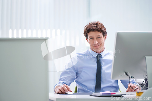 Image of Man, office and portrait with computer and desk, happy and confident corporate male person sitting in workspace. Technology, digital search administrator and smile, browse internet on business pc