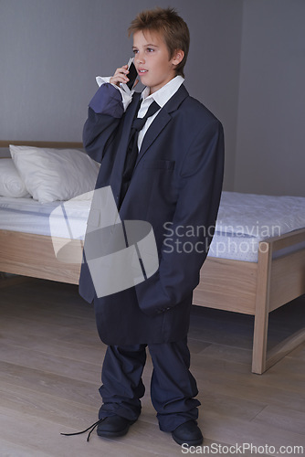 Image of Pretend, kid and phone call with boy in suit, smartphone or business for dream job and aspiration with dress up. Thinking, happy in clothes on career day, talk on communication technology in costume