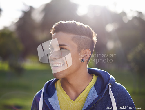 Image of Smile, happy and young man outdoor in nature, environment and park to relax on break with closeup. Male person, student gen z guy and student enjoying summer outside by trees, grass and lens flare