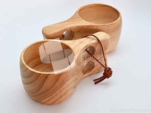 Image of two traditional finnish wooden kuksa cups on white background