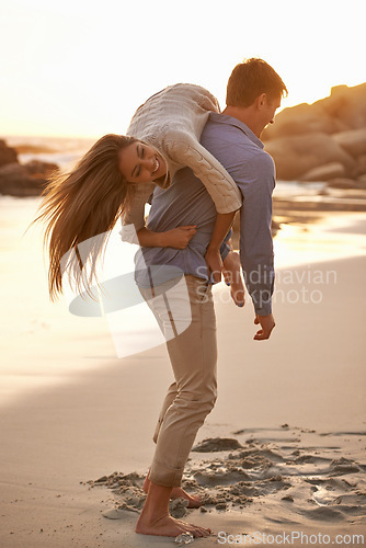 Image of Beach, man and woman with playful love together for romantic date, travel or holiday on island. Ocean, vacation and couple smile in sand for tropical adventure for honeymoon, anniversary and sunset