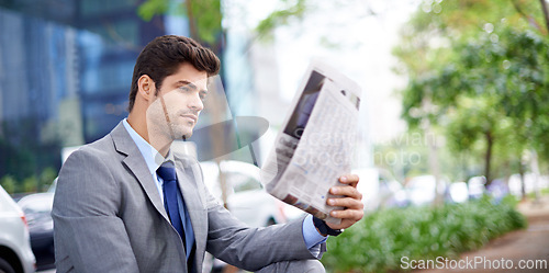 Image of Professional, businessman and reading newspaper in city for information, daily news and updates on local events. Outdoors, male person and serious with article for stories, journalism and newsletter