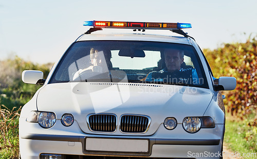 Image of Policeman, car and drive in field to search at crime scene or robbery, safety and law enforcement for evidence. Detective, investigation and uniform in outdoor working at countryside with gravel road