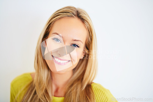 Image of Portrait, smile and woman in a house with confidence, positive attitude and feel good mood on white wall background. Face, happy and female person at home with optimism, relax and chilling on weekend