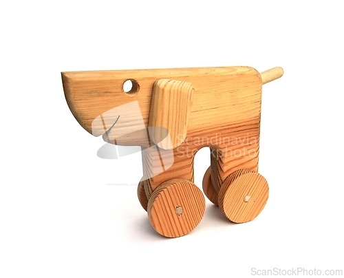 Image of funny wooden toy dog with wheels on a white 
