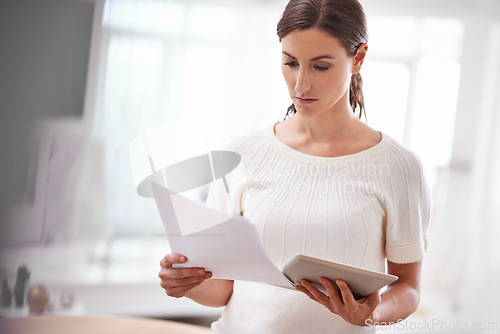 Image of Businesswoman reading, paperwork and tablet in office or technology, online documents with serious person. Entrepreneur, creative business planning and internet, social media website and browsing