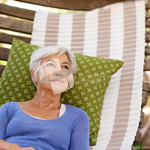Image of Senior woman, vision and outdoor with hammock to relax for retirement, break and enjoy. Thinking, female person and home with memories in summer or hot weather and satisfied with me time.