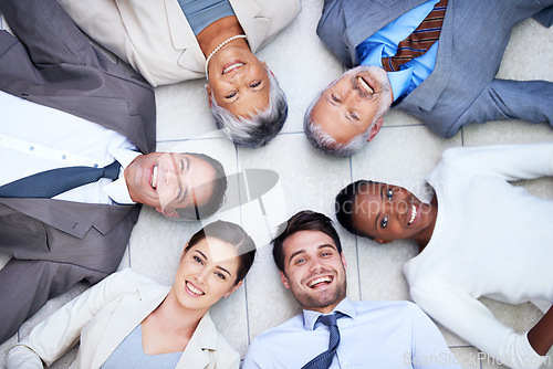 Image of Floor, circle and portrait of team with smile for support, collaboration and solidarity. Professional employees, happy and diversity in office with trust, unity and partnership together from above