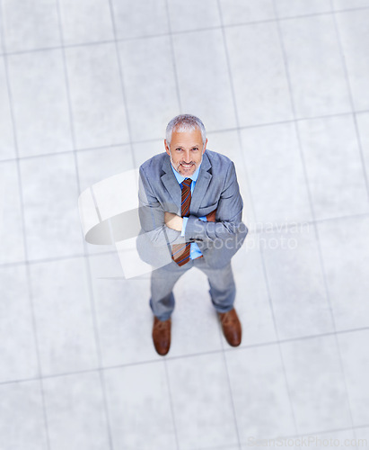 Image of High angle, portrait and happy man with arms crossed in business or office with confidence and pride. Mature, entrepreneur and above person in lobby excited for morning in London at workplace