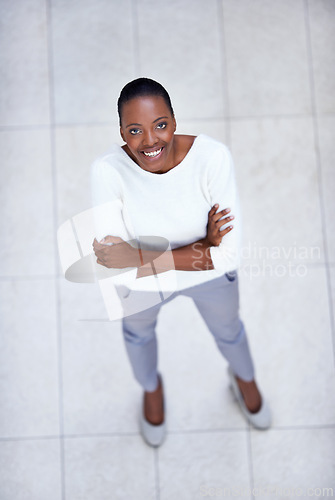 Image of High angle, portrait and happy woman with arms crossed in business or office with confidence and pride. African, employee and above person in lobby excited for morning in workplace in London