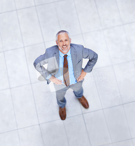 Image of Happy, man and high angle portrait in business or office with professional confidence and pride. Above, entrepreneur and mature person smile in lobby excited for morning in London at workplace