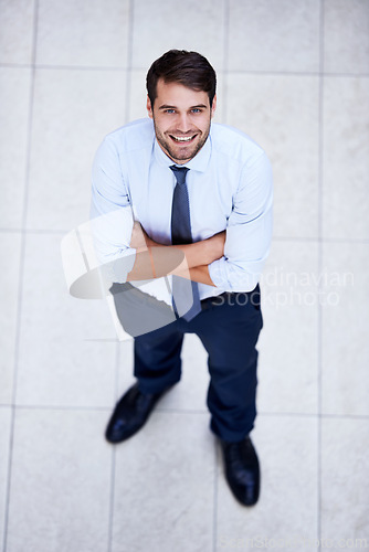 Image of Business, portrait and high angle of man with arms crossed in office with confidence and pride. Above, entrepreneur and person in lobby to start morning in corporate London workplace with perspective